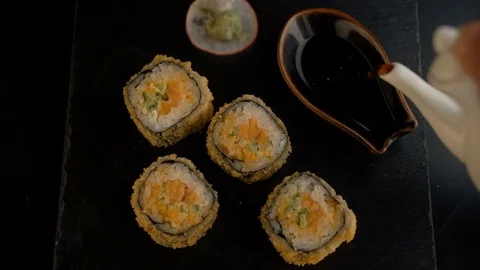 Сlose up of chopsticks taking portion of sushi roll on the table restaurant Stock Footage 69817378