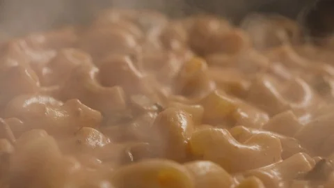 Сlose-up of ginger cheese drops in frying pan to pasta with mushrooms Stock Footage 113791514