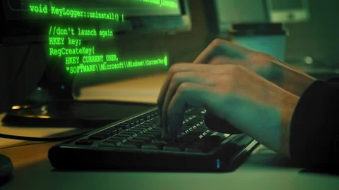 Сlose-up of hacker hands while green code characters fly out of the keyboard in Video stock 120502859