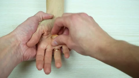Сlose-up of man's hands, which resolutely removes and gives the ring to woman Stock-Footage 235044610