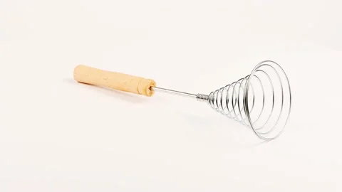 Сlose-up of old retro whisk kitchen tool on white background. Side view. Stock Footage 237693176