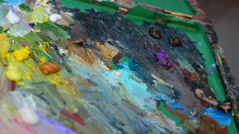 Сlose-up shot of camera moving over artist multicolored palette Stock Footage 289563804