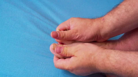 Сlose-up shot of a man’s hands massaging his tired foot 스톡 동영상 335684095
