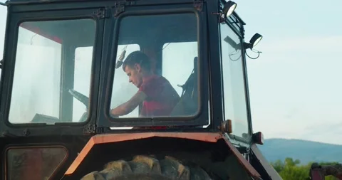 Сlose-up tracktor driver, farmer in Soviet tracktor cultivating land Stock Footage 211656685
