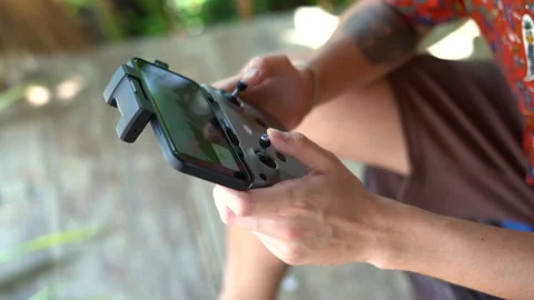 Сlose-up view of a man's hands operating the remote control of a drone Stock Footage 234860663
