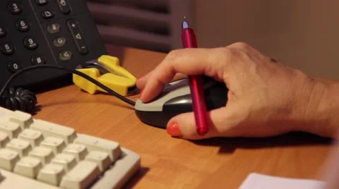 Сloseup of a hand using a computer mouse. On the table, keyboard and phone. Video stock 64636209