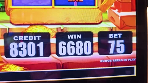 Slot machine bonus win display with bold numbers, vivid reel artwork, gold coin Stock Footage 340866696