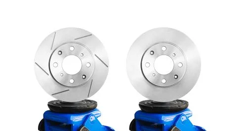 Slotted brake rotor and solid brake rotor on a hydraulic car jack isolated Stock Photos