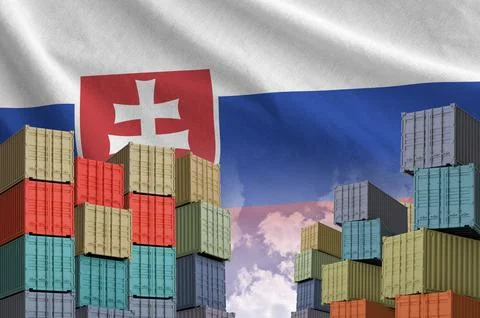 Slovakia flag and big stack of shipping cargo containers in docks with sky Stock Photos