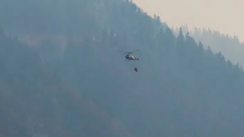Slovenian Armed Forces helicopter with a specialized bucket Stock Footage 182391124
