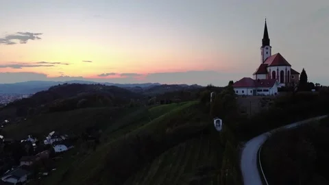 Slovenian church in a mountain from a drone during sunset Stock Footage