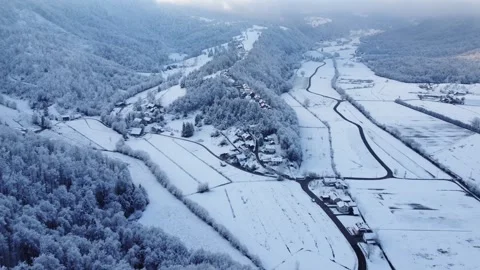 Slovenian Countryside Covered by a Thin Layer of Snow with Hills and a Valley Stock Footage 283375348