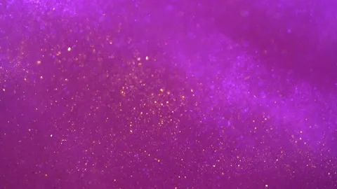 Slow abstract movement of flying gold particles on a magenta background. Video stock 219997688