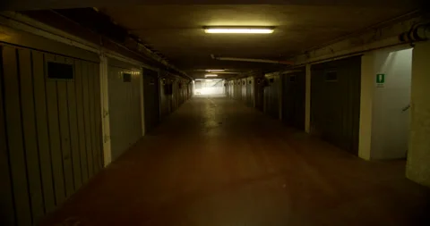 Slow Advance Down an Underground, Dimly Lit Parking Garage Stock Footage 203544305