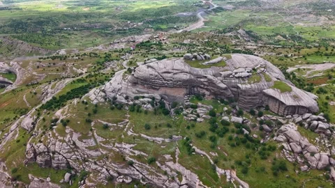 Slow Aerial Approach Toward Massive Rock Formation in Green Valley Stock Footage 344165082