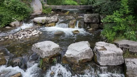 Slow aerial crawl over a small waterfall 4k footage Video stock 314808140