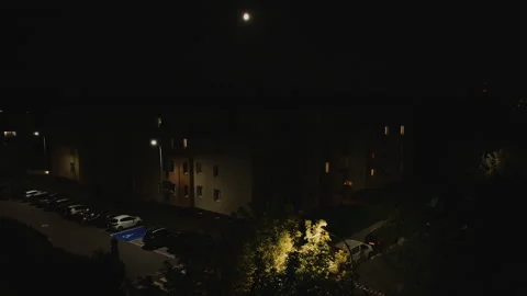 Slow Aerial Dolly Forward Towards Illuminated Building at Night Stock Footage 323769162