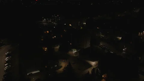Slow Aerial Drone Forward Flight Over Dark Neighborhood at Night Stock Footage 323769537