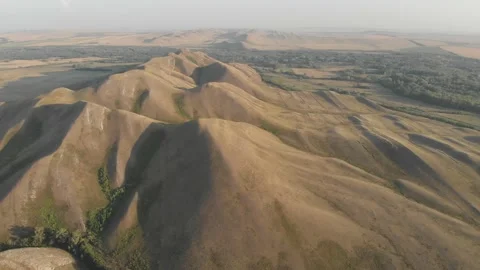 Slow aerial flight backwards over bald steppe mountains. Orenberg, South Ural Video stock 155999293