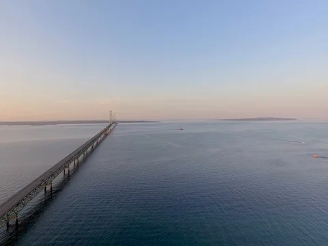 Slow aerial flight over Lake Huron parallel the Mackinac Bridge Stock Footage 80896332