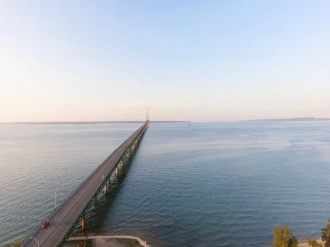 Slow aerial flight over Lake Huron parallel the Mackinac Bridge Video stock 80896398