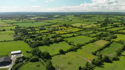 A slow aerial flight over the patchwork of fields in Wiltshire UK Video stock 196897059