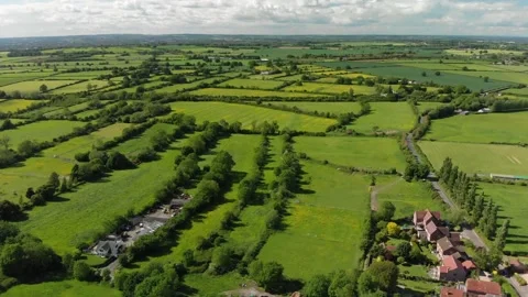 A slow aerial flight over the patchwork of fields in Wiltshire UK Stock Footage 196897643