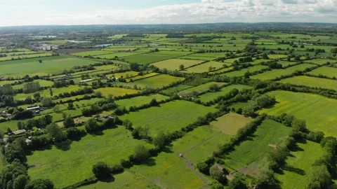 A slow aerial flight over the patchwork of fields in Wiltshire UK Video stock 196897819