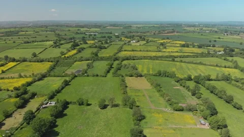 A slow aerial flight over the patchwork of fields in Wiltshire UK Video stock 196898547