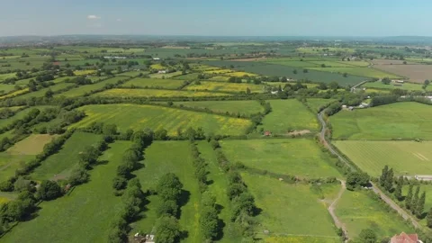 A slow aerial flight over the patchwork of fields in Wiltshire UK Video stock 196898691