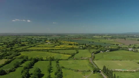 A slow aerial flight over the patchwork of fields in Wiltshire UK Video stock 196898930