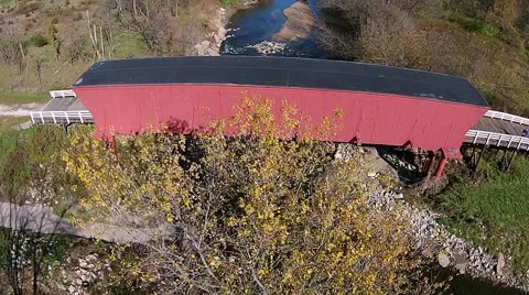 Slow aerial fly over of Roseman covered bridge Stock Footage