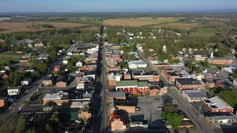 Slow aerial orbit to the left over Charles Town, West Virginia in morning light Stock Footage 129622552