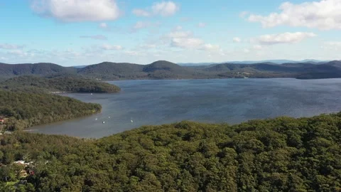Slow aerial over trees fly to Wallis lake in Booti Booti NP of Austrlaia as 4k. Stock Footage 200424469