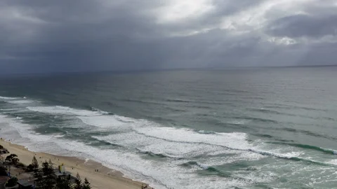 Slow Aerial Pan Across Cloudy Ocean Toward Beach on Gold Coast Australia Stock Footage 329366103