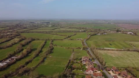 A slow aerial pan over the patchwork of fields in Wiltshire UK Stock Footage 172489157