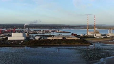 A slow aerial pan of Poolbeg Generating Station and the Dublin Waste facility Stock Footage 144850962