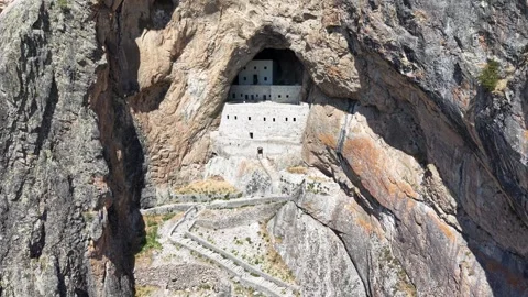 Slow Aerial Pullback Revealing Ancient Rock-Carved Stone Structure and Mountain 스톡 동영상 339457562