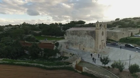 Slow Aerial shot approaching St Matthew's Chapel in Qrendi Stock Footage 92069723