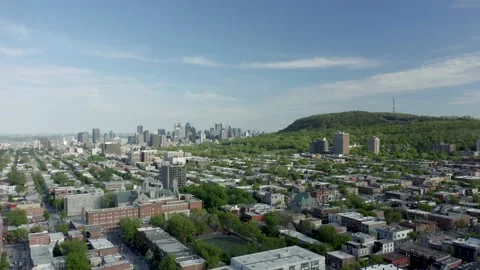 Slow aerial shot high in the air, showing Montreal's downtown and the Stock Footage 131492353