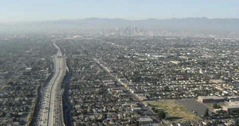 Slow aerial shot tracking down LA highway, overcast day Stock Footage 106091704