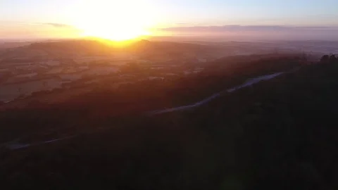 Slow aerial view of a cold walking route in the hills at sunrise. 스톡 동영상 71140698