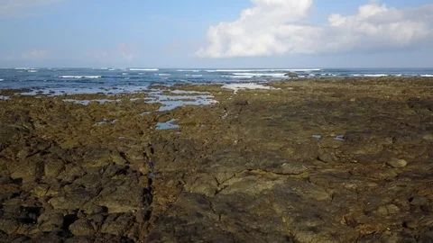 Slow and low flight over tidal pools and ocean at Playa Avellana Stock Footage 90919970