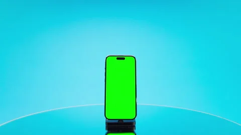 Slow Approach Toward Vertical Green Screen Phone on Blue Stock Footage 342837699