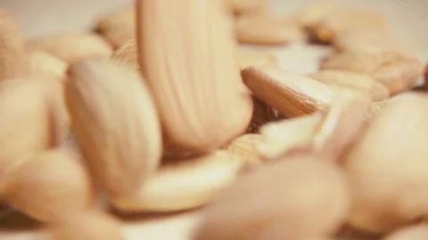 Slow apricot pits fall on the table close-up Video stock 94380636