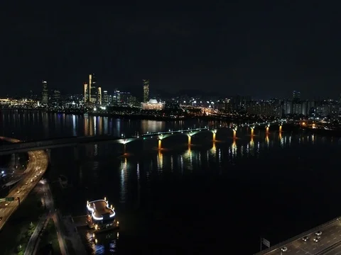 Slow ascent over a bridge, river, and traffic in Seoul Stock Footage