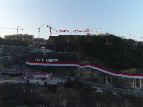 Slow ascent overlooking rock cliffs and construction in Bali Indonesia. Stock Footage 80156156