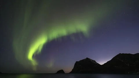Slow Aurora over the mountain coast Stock Footage 251362338