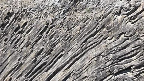 Slow Backward Drone Flight Revealing Detailed Rocky Cliffs in 4K Stock Footage 337773355