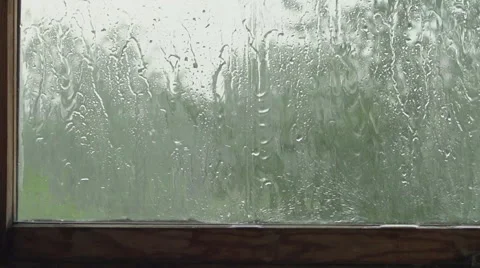 SLOW: A big raindrops falls behind a window Stock Footage 63509162